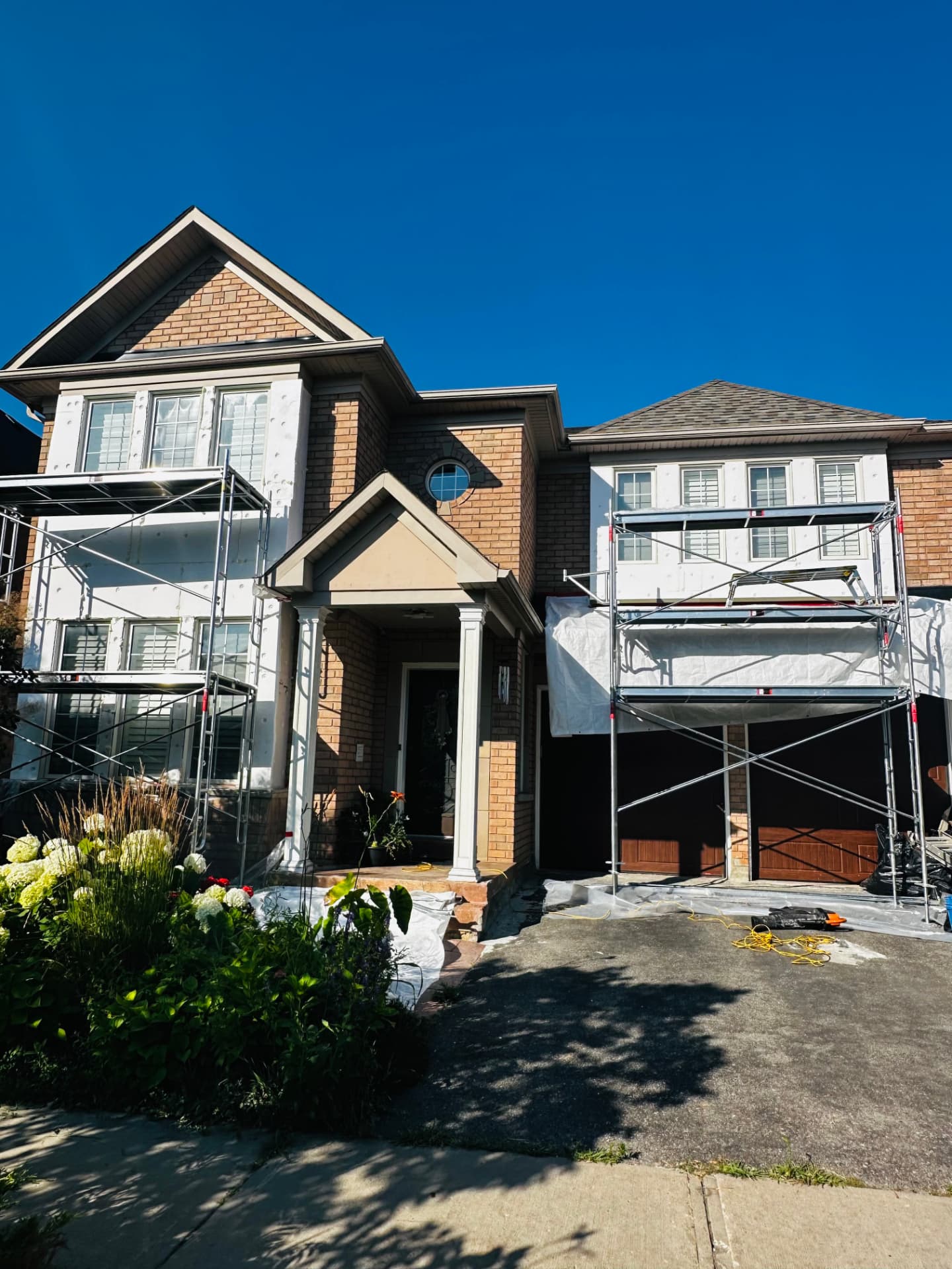 Brick two-storey with foam board fitted across the front elevation